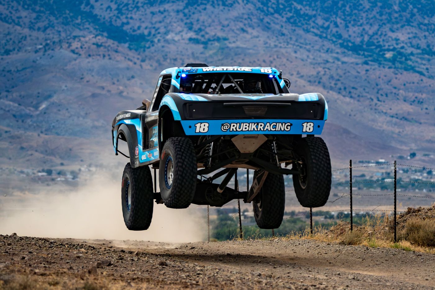 Unlimited Truck (2WD) race vehicle number 18 at speed, Nic Whetstone